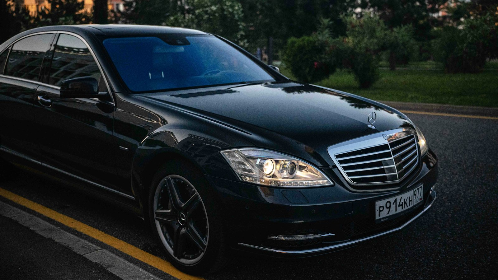 A black luxury sedan on the road